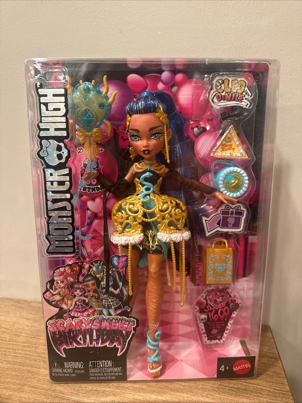 monster high doll in gold, blue & pink outfit